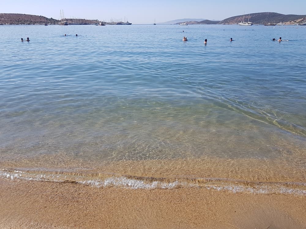 The lively and vibrant atmosphere of Gümbet Beach, with its numerous bars and water sports.