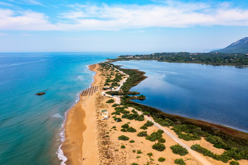 The vast, wild landscape of golden sand dunes at Issos Beach, next to Lake Korission, Corfu.