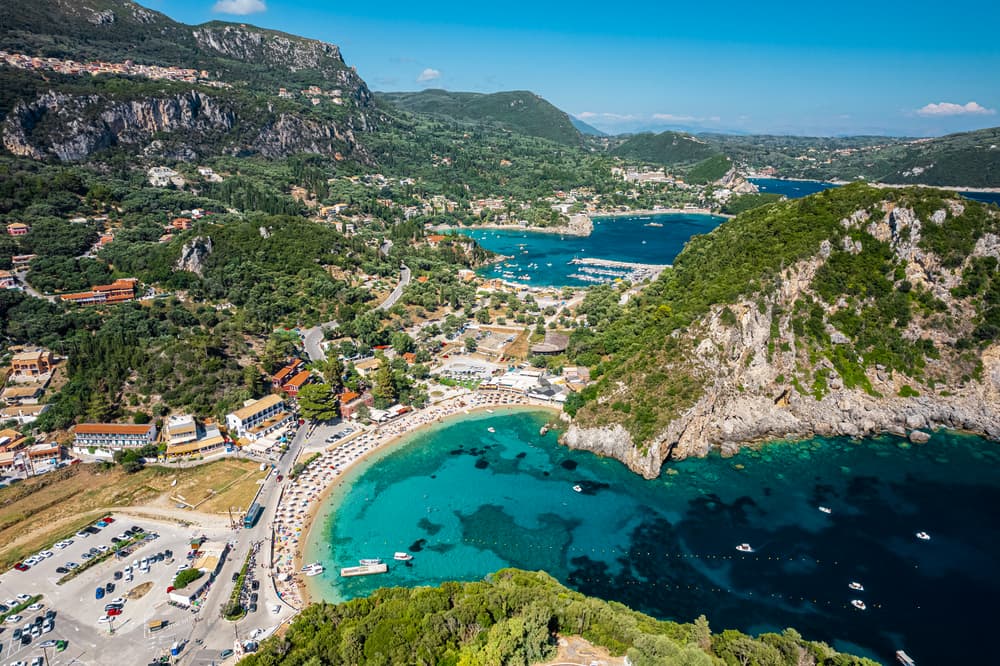 An aerial view of the multiple emerald bays and lush green hills of Paleokastritsa, Corfu.
