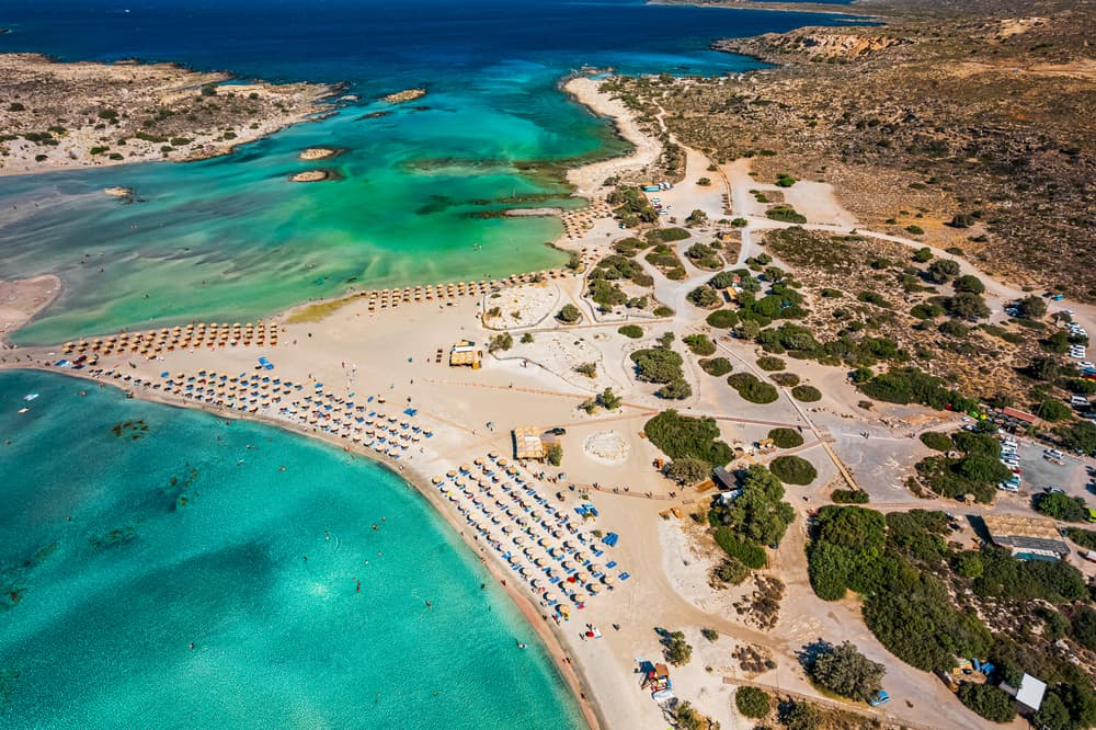 The world-famous pink sand and shallow turquoise lagoon of Elafonisi Beach in Crete.