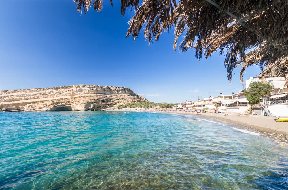 The iconic sandstone cliffs with Roman-era caves overlooking Matala Beach, Crete.