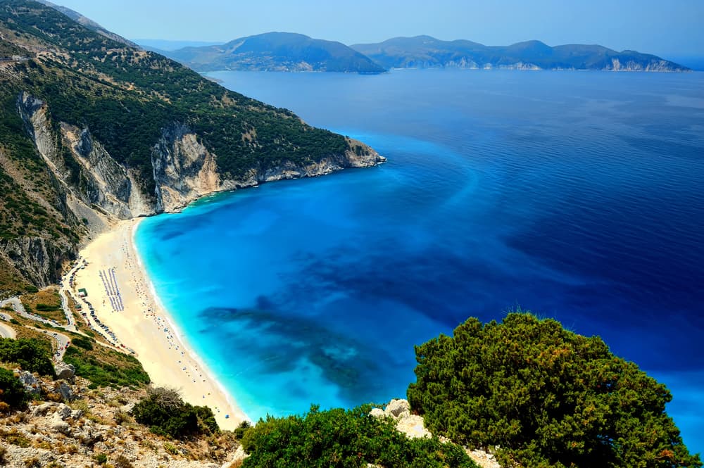 The world-famous arc of white pebbles and stunning turquoise sea of Myrtos Beach, Kefalonia, seen from above.