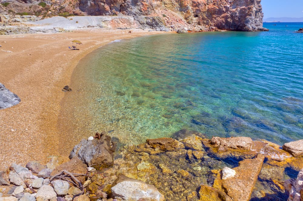 The abandoned ruins of the old sulfur mine on the yellow-stained shores of Paliorema Beach, Milos.