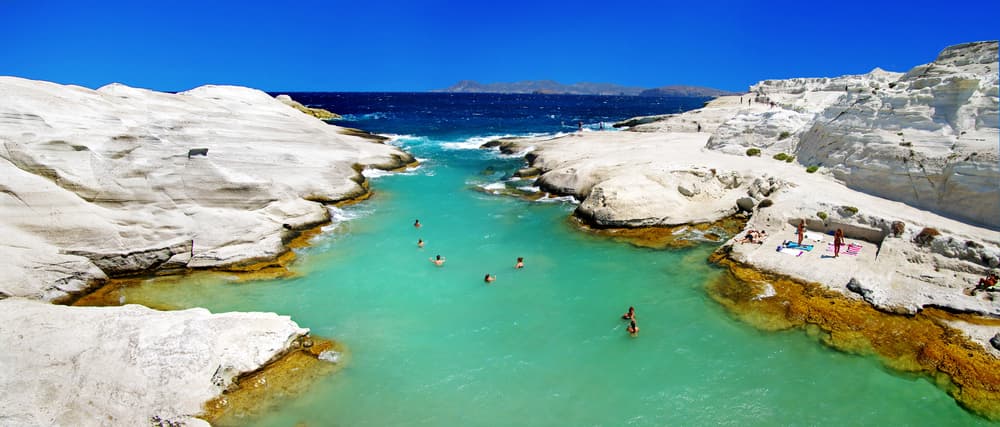 The dazzling white, bone-like volcanic rocks forming the unique lunar landscape of Sarakiniko Beach, Milos.