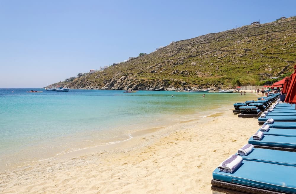 The turquoise waters and luxury yachts at Psarou Beach, Mykonos.