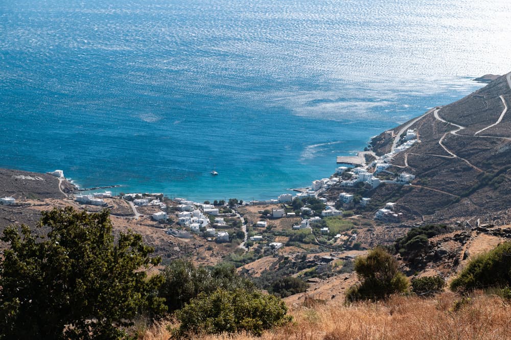 The beautiful pebble beach and famous seaside tavernas of Isternia Bay, Tinos.