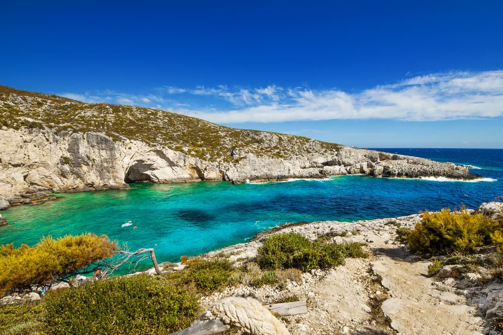 The stunning rocky fjord of Porto Limnionas with its deep turquoise water.