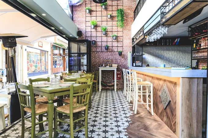 A lively table filled with authentic Cretan meze dishes and raki at Alla Ki Alla.