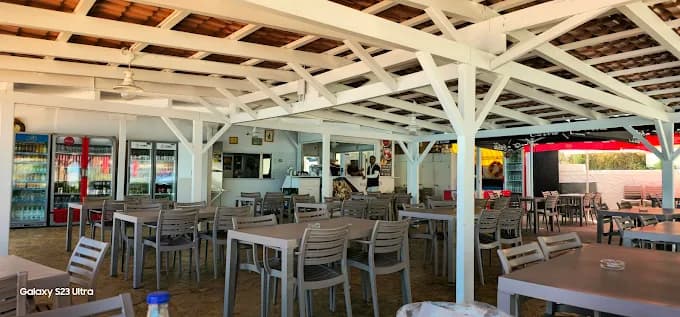 The spectacular sunset view over Petani Beach from the cliffside terrace of Erasmia's Taverna.