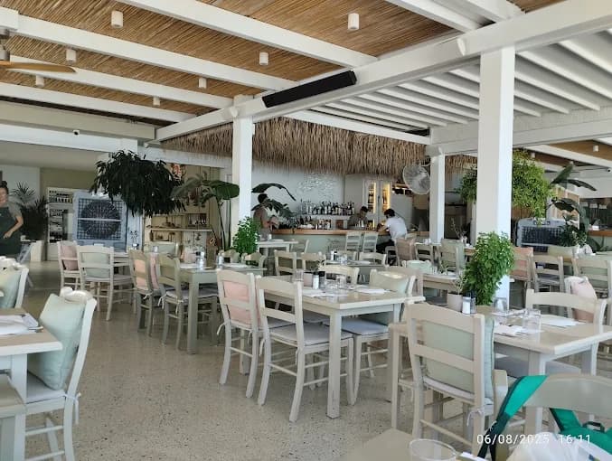 The chic, all-white decor of Barbouni restaurant on the bustling harbor of Kos Town.