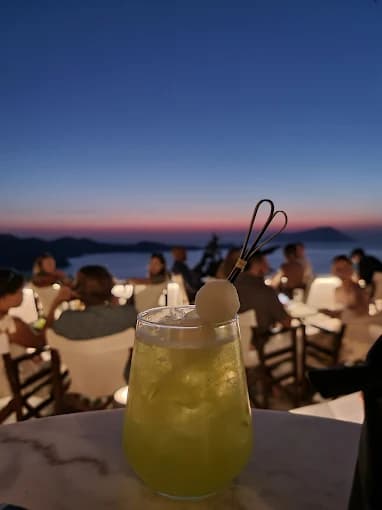 The breathtaking panoramic sunset view over the Aegean Sea from the terrace of Utopia Caffe in Plaka.