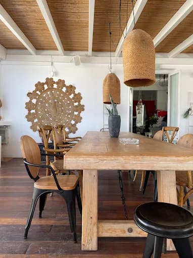 A cocktail on the rooftop of 520 Bar with the Portara of Naxos in the background at sunset.
