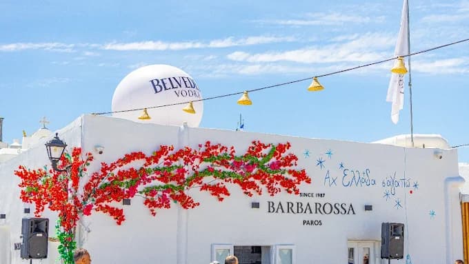 The iconic waterfront tables of Barbarossa restaurant in the picturesque old port of Naoussa.