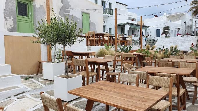 The sun setting over the Aegean Sea from the relaxed terrace of Come Back Bar in Parikia.