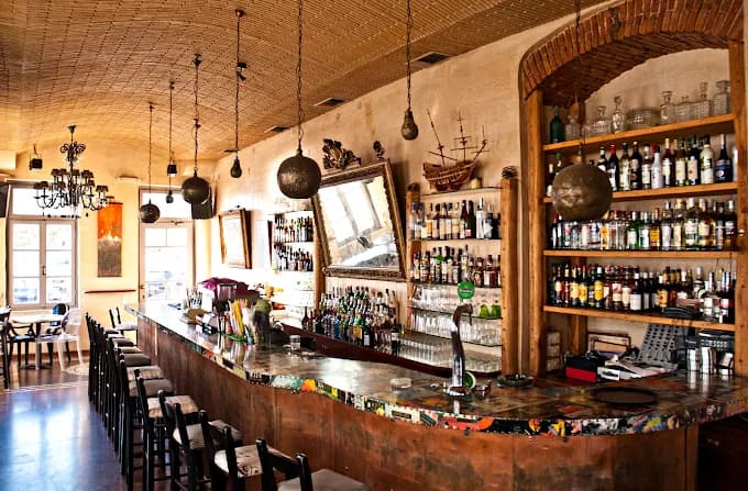 The unique, atmospheric pirate-ship themed interior of the legendary Koursaros Bar in Tinos.