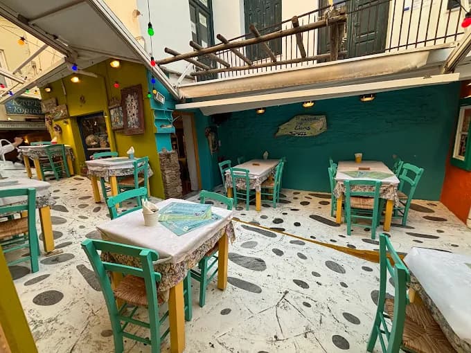 A cozy, traditional table setting inside the famous To Koutouki tis Elenis taverna.